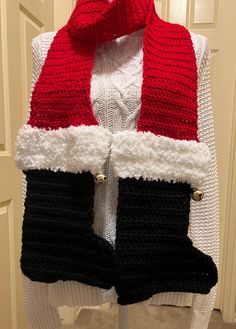 Holiday scarf features Santa's legs and boots.  Each boot has a jingle bell attached.  Bright red legs with black boots and fur top.  Each boot is 11 inches long and 10 inches wide at the heel.  The legs are 60 inches long and 6 inches wide.  The total length of the scarf is 82 inches.   A great gift exchange idea or wear it yourself for some cute holiday flare. Holiday Scarves, Santa Boots, Fur Top, Jingle Bell, Gift Exchange, Oklahoma City, Jingle Bells, 11 Inches, Bright Red