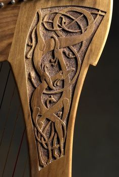 an intricately carved wooden instrument with strings