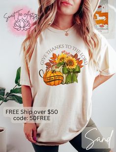 a woman wearing a t - shirt with sunflowers and pumpkins on it