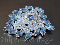 "Enormous Vintage DeLizza and Elster Juliana Blue on Blue Rhinestone Brooch  | Collectors know that these companies used hang tags, and so there are no markings. The hallmarks of this maker are obvious. Prong set rhinestones with a large open backed stone. Well made. Intricate design. Unbelievably beautiful.  The texture is stunning.  It throws light everywhere. This piece would look just as spectacular on a tuxedo. 2.25\" x x2\" inches across. No issues whatsoever. We sell select vintage items. Costume Jewelry Blue Brooches With Rhinestones, Collectible Hallmarked Blue Brooches, Vintage Blue Diamond Brooches, Luxury Blue Victorian Brooch, Blue Crystal Brooches With Rhinestones, Vintage Blue Brooches With Rhinestones, Rhinestone Brooches, Blue Rhinestones, Hang Tags