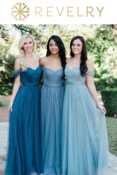 three bridesmaids in blue dresses posing for the camera with their arms around each other