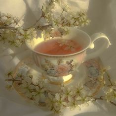 a tea cup and saucer with flowers on it