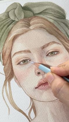 a drawing of a woman's face in watercolor with a pen and marker