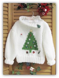 a white sweater with a christmas tree on it