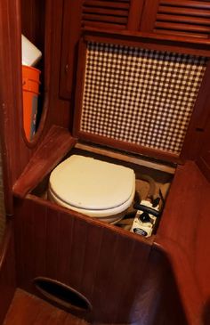 an open toilet in a wooden bathroom stall