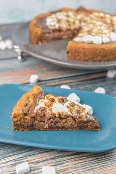 a slice of s'mores cheesecake on a blue plate with marshmallows