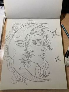 a drawing of a woman's face with stars on the paper next to it