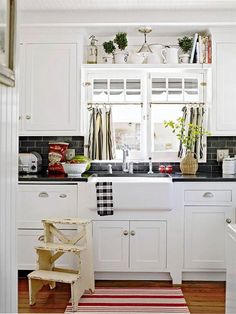 the kitchen is clean and ready for us to use it's white cabinetry