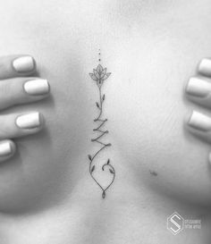 a woman's stomach with an arrow tattoo on her chest and the word love written in