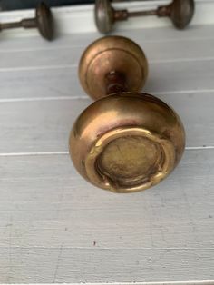 an old brass door handle on a white wooden door