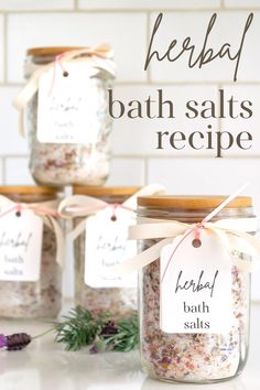 three jars filled with bath salts sitting on top of a counter