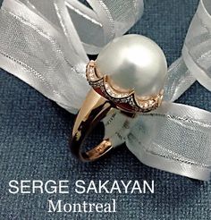 This stunning, 1-of-1 piece was masterfully crafted by renowned jewelry designer Serge Sakayan, in Montreal's Diamond District. Featuring a large, 17mm white South Sea button pearl, with .55 carats of VS-quality diamonds surrounding its base, this amazing ring makes a bold fashion statement.  Designed to make a statement, this piece features a refined, hand-crafted setting finished in 14K rose gold.  A genuine eye-catcher, rest assured that this cocktail ring will truly take your breath away! ITEM INFORMATION  -- SKU # 08SS60R14PL  Total Diamond Weight: 0.55 Carat (TDW) Main Stone: 17mm South Sea Pearl Number of Stones: 1 Stone Shape: Button Stone Color: White Stone Quality: AAA Stone 2: Side Stones Stone Shape: Round Cut / Round Diamond Accent Diamond Cut: Very Good Diamond Color: F-G Dia Luxury Pearl Cabochon Ring For Formal Occasions, Luxury Pearl Ring With Round Cut, Luxury Polished Round Cut Pearl Ring, Luxury Rose Gold Diamond Pearl Ring, Luxury Formal Pearl Ring With Cabochon, Luxury Rose Gold Cabochon Rings, Luxury Exquisite Round Cut Pearl Ring, Luxury Classic Multi-stone Pearl Ring, Pearl Cocktail Ring