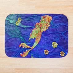 a bath mat with an image of a sea horse and fish in the ocean on it