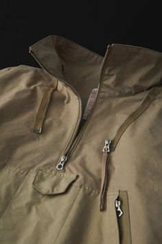 This cold-weather parka is a cross between a 1940s British smock and the design and specifications of an American mountain parka, developed in a unique interpretation. The fabric was commissioned to the first factory in Japan to be certified as an official producer of military uniform fabrics. Egyptian Giza cotton is used and woven to the highest possible density to provide water repellency. Beige Parka With Detachable Hood For Outdoor, Beige Parka With Detachable Hood For Streetwear, Khaki Utility Windbreaker With Double-lined Hood, Beige Streetwear Parka With Detachable Hood, Utility Khaki Windbreaker With Double-lined Hood, Utility Style Khaki Windbreaker With Double-lined Hood, Beige Parka With Pockets For Outdoor, Beige Parka With Adjustable Hood For Streetwear, Beige Hooded Jacket With Detachable Hood For Outdoor