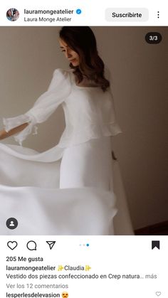 the woman is wearing a white dress with long sleeves and ruffles on it