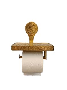 a gold toilet paper holder with a lion head on it's back and two rolls of