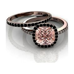 two engagement rings with black diamonds and a pink diamond in the center on a white background