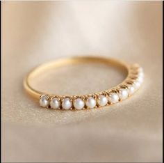 Luxury Dainty Pearl Ring For Anniversary, Gold Pearl Wedding Band, Dainty Stackable Pearl Promise Ring, Fine Jewelry Stackable Pearl Ring With Round Band, Dainty Pearl White Ring For Anniversary, Adjustable Stackable Pearl Ring In Fine Jewelry Style, Stackable Pearl Ring For Anniversary, Elegant Stackable Pearl Ring For Promise, Elegant Stackable Pearl Promise Ring