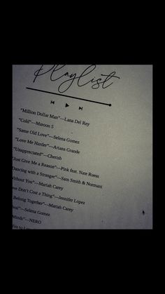 a close up of a piece of paper with writing on it and the words playlist written in cursive ink