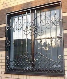 a window with wrought iron bars on it