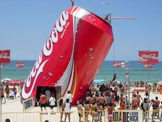 a giant coca cola boat on the beach