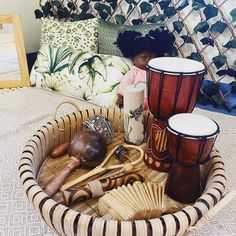 a basket filled with musical instruments on top of a bed