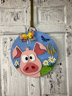 a door hanger with a pig face on it