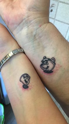 two people with matching tattoos on their arms