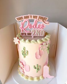 a birthday cake with pink frosting and decorations