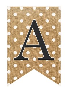 a brown and white polka dot banner with the letter a on it's side