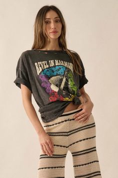 Distressed, mineral washed graphic t-shirt.
Torn and distressed detailing at neckline, cuffs, and hem.
Vintage-style "Revel In Harmony" text print with Earth, guitar, and flower graphics.
Round neckline.
Short sleeves.
Drop shoulder.
Oversized fit.
100% Cotton.
Imported top designed and printed in LA.
Model wears size S. Vintage Stonewashed T-shirt For Spring, Stonewashed Graphic Tee For Spring, Spring Stonewashed Graphic Tee, Stonewashed Grunge T-shirt For Summer, Grunge Style Festival T-shirt For Spring, Spring Festival Grunge T-shirt, Spring Festival Distressed T-shirt, Trendy Summer Stonewashed T-shirt, Spring Acid Wash T-shirt With Frayed Hem