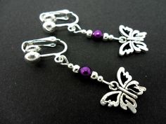 This a pair of pretty tibetan silver dangly butterfly clip on earrings. Measure approx. 4cm from top of hook to bottom of earring. These earrings are not for pierced ears. Freshly made by me and unworn. Thanks for looking!! Adjustable Nickel-free Butterfly Jewelry, Adjustable Butterfly-shaped Nickel-free Jewelry, Adjustable Butterfly Jewelry Nickel Free, Purple Metal Dangle Earrings, Purple Dangle Metal Earrings, Handmade Metal Butterfly Earrings, Handmade Butterfly Metal Earrings, Silver Drop Earrings With Butterfly Charm, Nickel-free Adjustable Butterfly Earrings