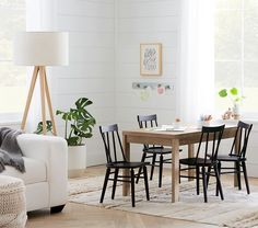 a living room with a couch, table and chairs