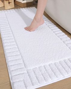 a person is standing on a bath mat