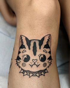 a black and white cat tattoo on the leg