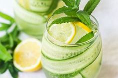 two glasses filled with cucumber and lemonade