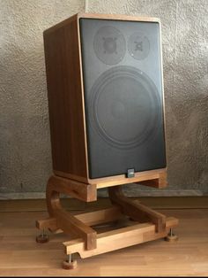 a speaker sitting on top of a wooden stand