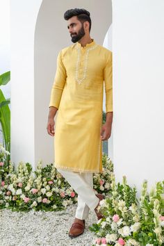 Yellow kurta with placed cutdana embroidered floral motifs. Comes with trouser. Components: 2 Pattern: Embroidered Type Of Work: Thread, Cutdana Neckline: Mandarin Collar Sleeve Type: Full Fabric: Kurta: Cotton Blend, Trouser: Cotton Silk Color: Yellow Other Details:  Closure: Kurta: Front button Occasion: Sangeet,Mehendi and Puja - Aza Fashions Diwali Mens Kurta, Simple Kurta For Men, Yellow Kurta Men, Haldi Ceremony Outfit For Men, Kurtas Men, Trouser Men, Trouser For Men, Haldi Ceremony Outfit, Brothers Wedding