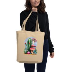 Say goodbye to plastic, and bag your goodies in this organic cotton tote bag. There's more than enough room for groceries, books, and anything in between. * 100% certified organic cotton 3/1 twill * Fabric weight: 8 oz/yd² (272 g/m²) * Dimensions: 16″ × 14 ½″ × 5″ (40.6 cm × 35.6 cm × 12.7 cm) * Weight limit: 30 lbs (13.6 kg) * 1″ (2.5 cm) wide dual straps, 24.5″ (62.2 cm) length * Open main compartment This product is made especially for you as soon as you place an order, which is why it takes Organic Cotton Canvas Bag For Gift, Eco-friendly Organic Cotton Canvas Tote Bag, Eco Tote Bag, A Plus, Cotton Tote Bags, Fabric Weights, Organic Cotton, Bathing Beauties, Accessory Gift