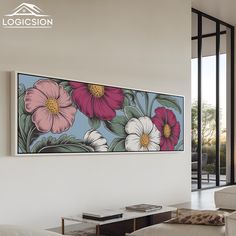 a painting hanging on the wall in a living room with white furniture and large windows