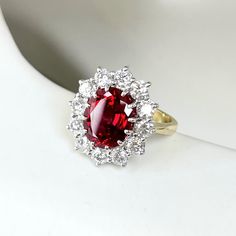 Talk about modern heirloom. This ruby ring is two-tone and antique-inspired. Choose from three options for the gem size. About this ring: Platinum 14k yellow gold shank Small: 8x6 ruby, hand-selected and Chatham lab created, ~1ctw diamonds Medium: 9x7 ruby, hand-selected and Chatham lab created, ~1.1ctw diamonds Large: 10x8 ruby, hand-selected and Chatham lab created, ~1.25ctw diamonds Diamonds: Color G, Clarity VS-SI Photo shown: large version in size 5 Measurements: width: 2.5mm This piece is Antique Ruby Ring Victorian, Diamond Ruby Ring, Ruby Halo Ring, Ruby Jewelry Ring, Queen Maeve, Red Diamond Ring, Antique Ruby Ring, Strawberry Ring, Ruby Ring Vintage