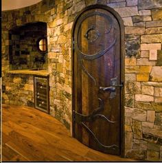 a kitchen with stone walls and wooden floors