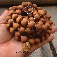 "📿Tulsi Mala handcrafted with Brown Tulsi beads. Suspended in the center is the engraved \"Krishna & Radha\" Guru Bead. When someone wears the tulsi mala, around your neck or around your wrist, you feel protected and focussed. It actually goes a long way in helping you deal with the stress of modern life.📿 🚪 Dimensions ( Approximately ) 🚪 📏Bead size: 11 MM - 12 MM 📏No. of beads: 108 Mala Bead + 1 Guru Bead 📏Mala Necklace Length: 50.0 - 51.0 inches 🚪 Pure Tulsi Beads Sourced from Vrindava Meditation Jewelry With Wooden Round Beads, Meditation Jewelry With Round Wooden Beads, Wooden Beads Jewelry For Meditation, Artisan 108 Beads For Meditation, Healing Wooden Beads Jewelry For Festivals, Artisan Wooden Beads Bracelet For Meditation, Brown Polished Beads Mala For Meditation, Spiritual Mala With Round Wooden Beads, Spiritual Polished Beads For Meditation