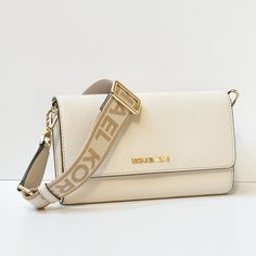 New With Tag Michael Kors Jet Set Item Large Zip Around Wallet Crossbody Bag Pebbled Leather Light Cream 100% Authentic Retail: $348.00 Plus Tax **Please See The Measurement For The Size* No Dust Bag Michael Kors Logo At Front Flap Closure Smooth Leather On Flap Top Closure Exterior Back Zip Pocket Gold Toned Hardware Custom Fabric Lining 2 Open Compartments And A Middle Zip Around Middle Compartment: 12 Card Slots, 4 Bill Pockets 8"(L) X 4.75"(H) X 2"(D) Strap: 23" Adjustable Very Clean, Smoke- Michael Kors Jet Set Large Crossbody Bag, Large Crossbody Bag, Michael Kors Logo, Large Crossbody Bags, Bag Light, Light Cream, Kors Jet Set, White Bag, Michael Kors Jet Set