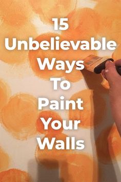 a person painting an orange wall with the words 15 unbelevable ways to paint your walls