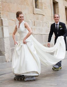 a bride and groom are riding skateboards together