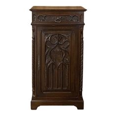 an ornate wooden cabinet with carvings on the front and side panels, in dark wood