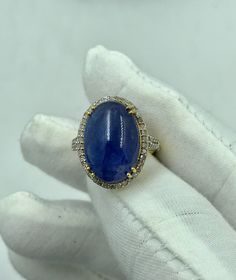 "Natural Tanzanite Ring, 14K Solid Gold Ring, Diamond Ring in 14k gold Anniversary Ring For Woman's Ring For Her Engagement Ring gift for her Gem: Tanzanite Cabochon  Gem size & shape: 11x18 mm and Oval Gem weight: 12.22 Carats One of a kind engagement ring for a woman\" - that is what comes to mind when you see this ring. We absolutely believe that your partner will fall in love with  this piece, the same way our women's team falls in love with it. RING TYPE - ENGAGEMENT RING,PROMISE RING,BRIDAL RING,SOLITAIRE RING,WEDDING RING,ANNIVERSARY RING,CUSTOM RING,FINE JEWELRY,STACKING RING,GIFT FOR HER,BIRTHDAY RING \"HANDMADE WITH LOVE\" MADE IN INDIA YOUR ORDER IS MADE TO ORDER.  CUSTOMIZATION  Main stone: Tanzanite Cabochon  Main stone weight: Approx 12.22 ct Metal type: 14k Yellow Gold  Side Jewelry Stacking, Gold Ring Diamond, Gold Anniversary Rings, Handmade Jewelry Box, Semi Precious Gems, Gold Anniversary, Solid Gold Ring, Tanzanite Ring, Birthday Ring