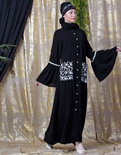 Easy to wear and handle Partywear abaya Classy and elegant Executive formal Abaya Elegant and trendy kaftan for every occasion Loose and elegant trendy fit to all Premium Shine Nida Fabric with rich look Hijab and band shown in the image can be bought separately Fabric: 100% Polyester Crepe ( Matt Finished Nida)Care: Mild machine wash/ hand Cold Wash/ Dry cleanWe request customers to carefully choose the correct size and dress length referring to our size chart Black Long Sleeve Hijab For Eid, Black Long Sleeve Khimar With Dabka, Black Floor-length Abaya With Dabka Work, Elegant Embroidered Black Abaya, Modest Black Kaftan For Eid, Modest Embroidered Maxi Abaya, Embroidered Modest Maxi Abaya, Elegant Black Agbada For Eid, Black Long Sleeve Agbada For Eid