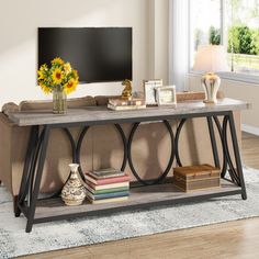 a living room with a couch, coffee table and television on top of the tv stand